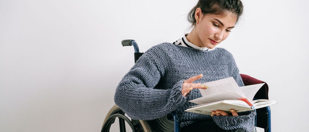 Girl in wheelchair studying